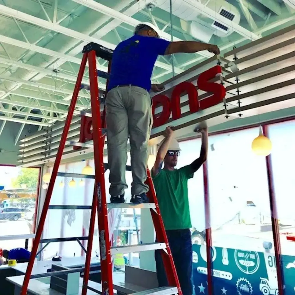 Dimensional signage installation by Action Services & Programs