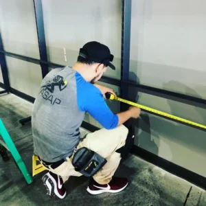 Action Service technician measuring a retail store fixture.