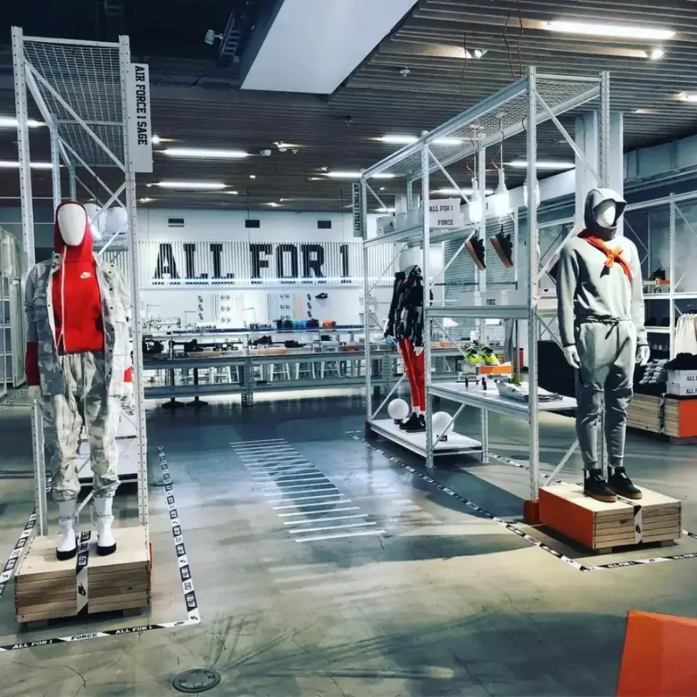 Completed retail store fixture installation featuring apparel displays, mannequins, and merchandising fixtures